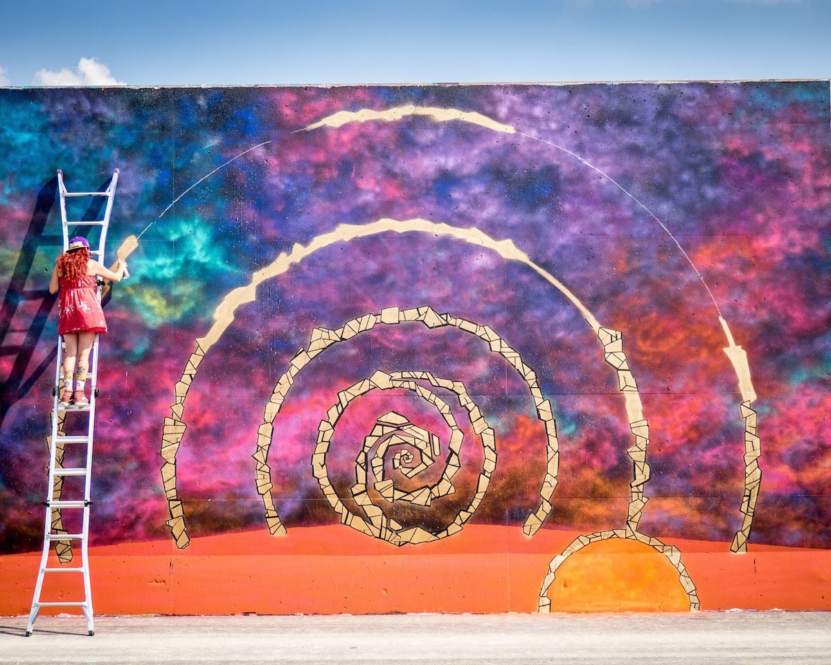 Image of artist creating a spiral mural